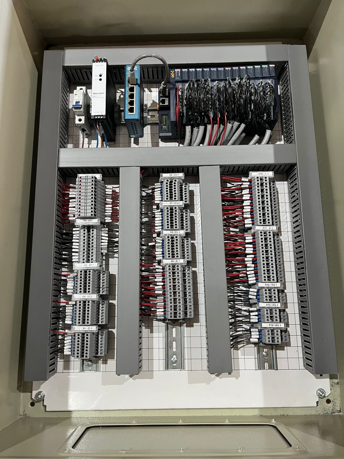 Industrial Ethernet communication panel with Korenix network switch, Balluff IO-Link Master and PLC I/O modules installed by Proplant PCE.
