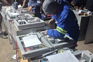 Technician assembling industrial electrical control systems in the Proplant PCE engineering workshop.
