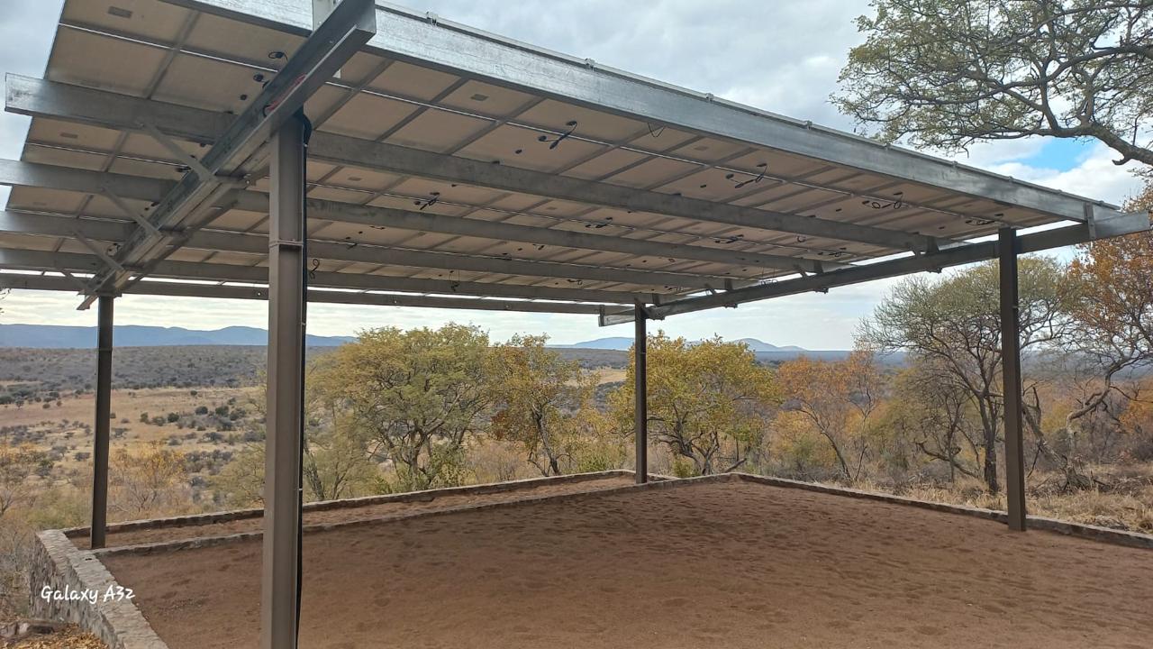 Commercial solar carport installation providing renewable energy and covered parking for an industrial facility.