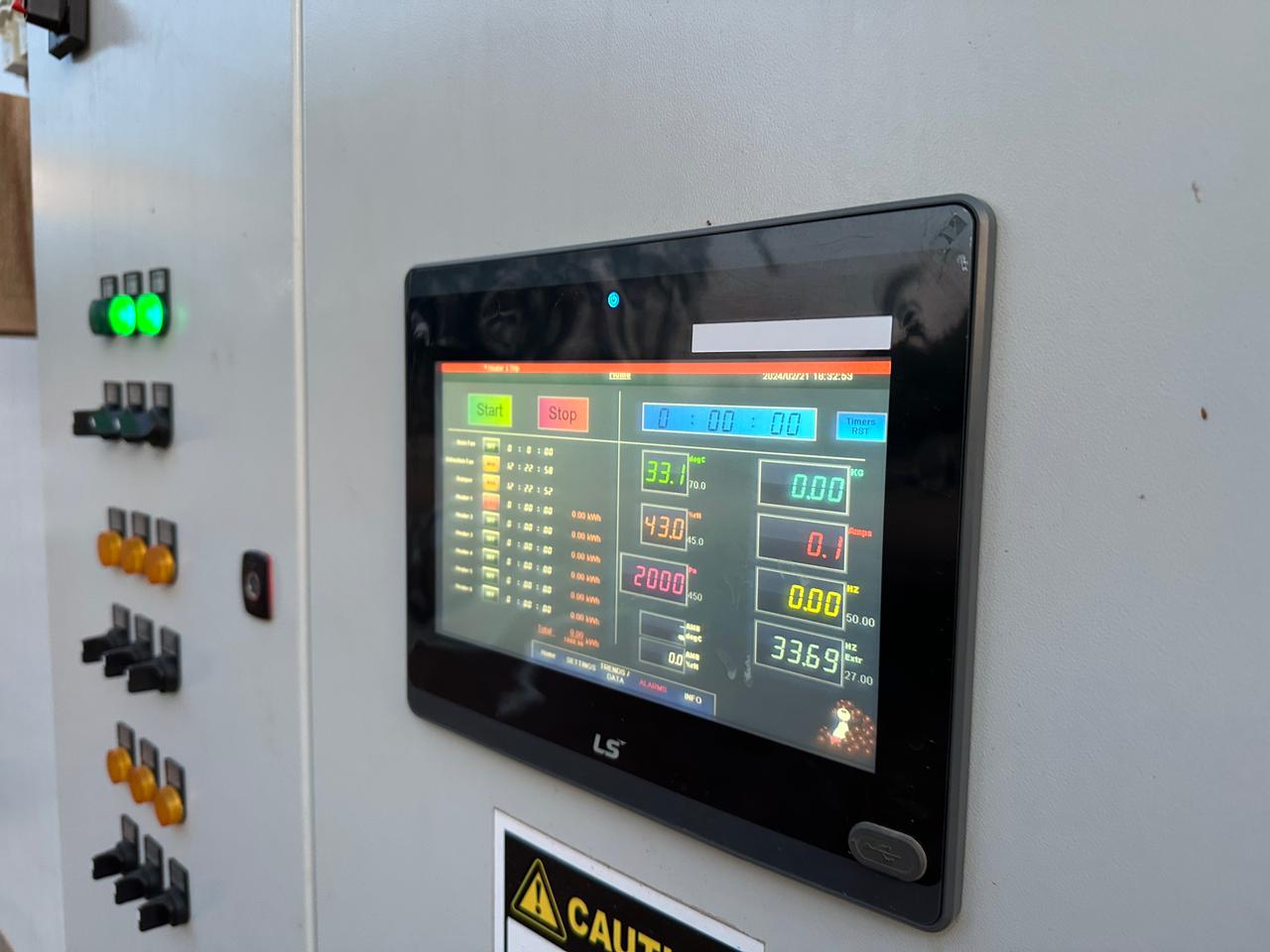 Industrial HMI operator panel displaying real-time process data and production information.