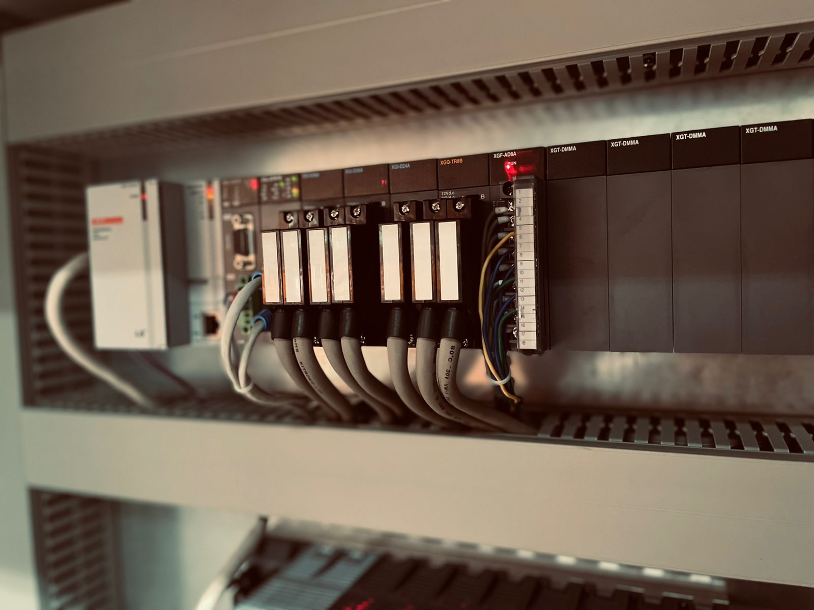 Close-up of industrial PLC controller with input and output modules inside a control cabinet.