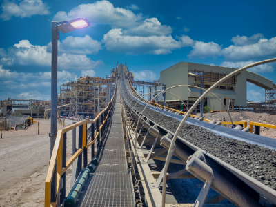 Industrial mineral processing plant with conveyors, grinding equipment and slurry processing systems